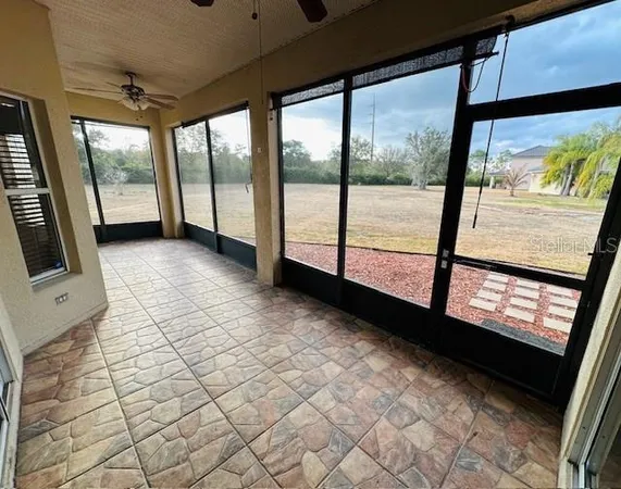 a view of an empty room with a floor to ceiling window