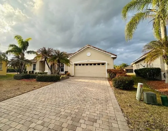 a front view of a house with a yard and a garage