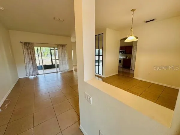 a hallway with a wooden floor and a window