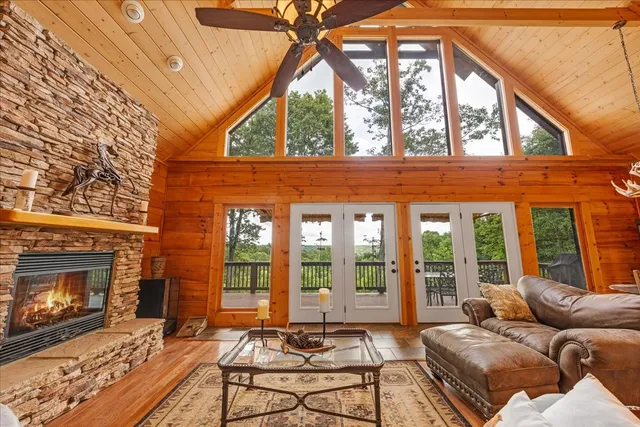 a living room with a fireplace furniture and a floor to ceiling window