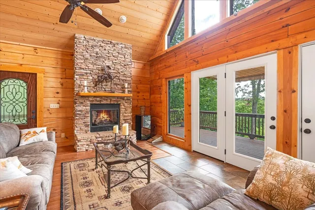 a living room with furniture and a floor to ceiling window
