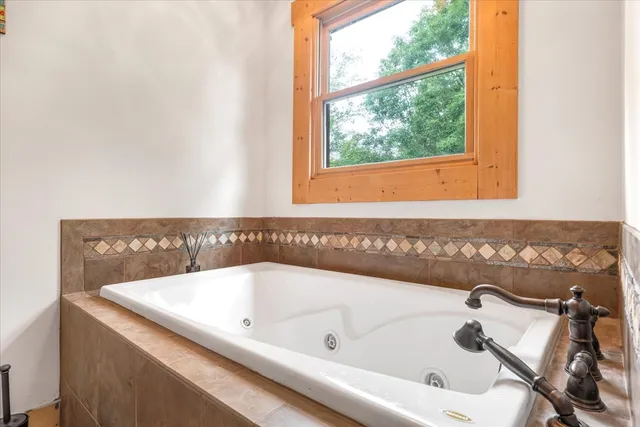 a bath tub sitting next to a window