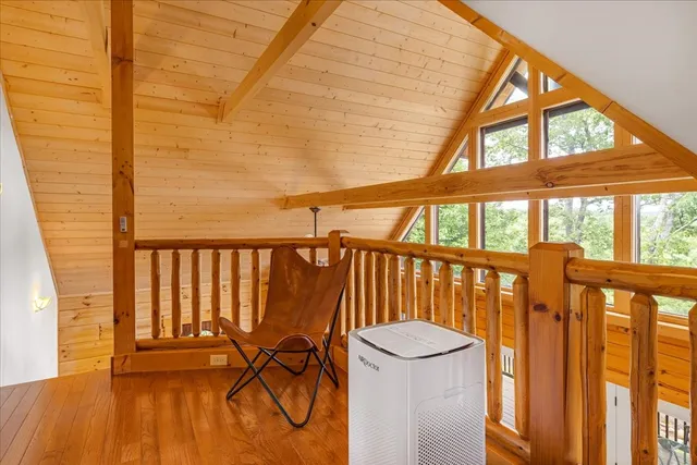 a view of a balcony with wooden floor and outdoor seating