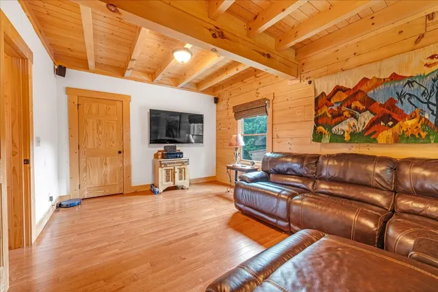 a bathroom with a granite countertop sink vanity mirror and toilet
