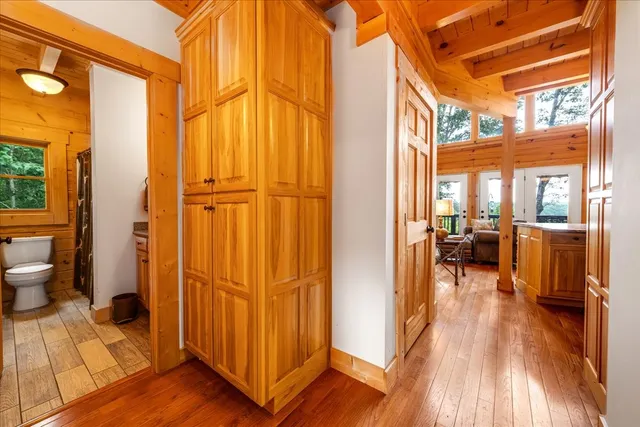 a balcony with wooden floor and outdoor seating