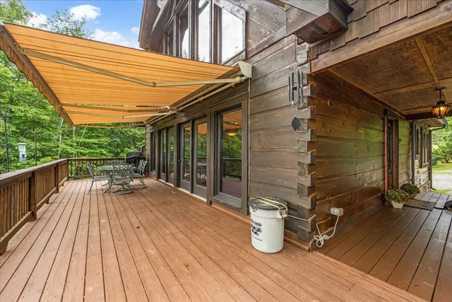 a view of balcony with wooden floor and outdoor seating