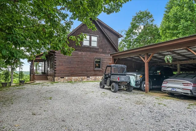 a house view with swimming pool and trees in the background
