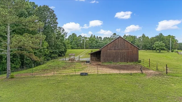 a backyard of a house with table and chairs