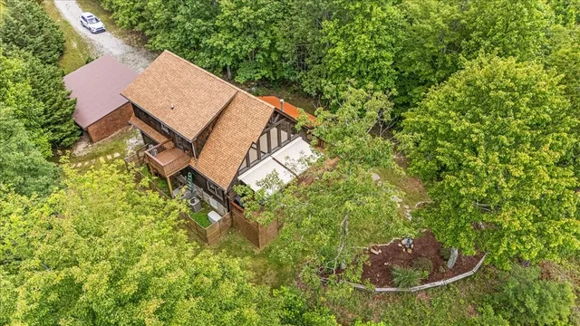 a view of a house with a backyard and trees