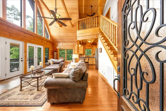 a living room with large windows and wooden floor