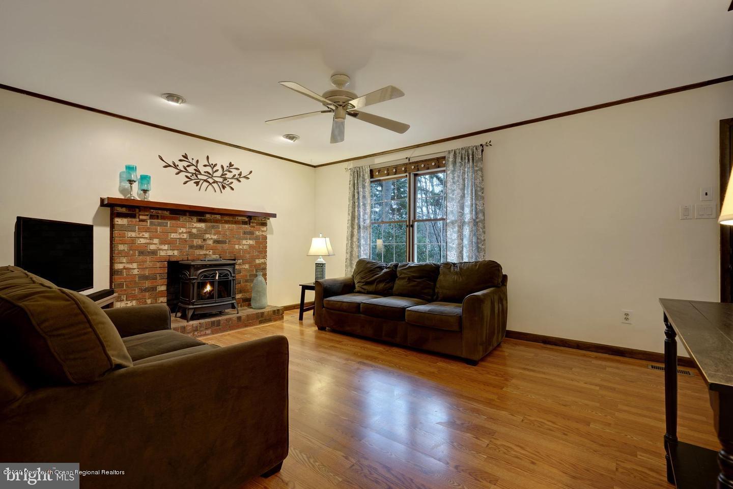 104 Ahoy Road Manahawkin, NJ 08050 - Photo 7 of 32 a living room with furniture and a fireplace