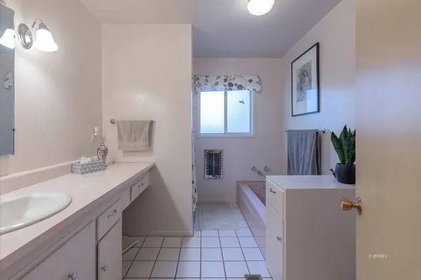 a bathroom with a sink a vanity and a mirror