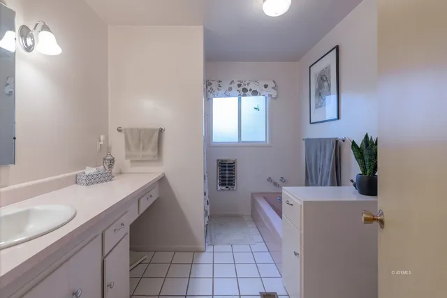 a bathroom with a sink a vanity and a mirror