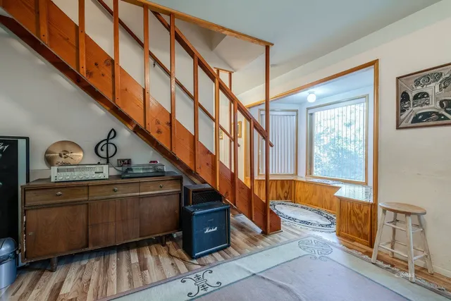 a view of entryway and hall with wooden floor