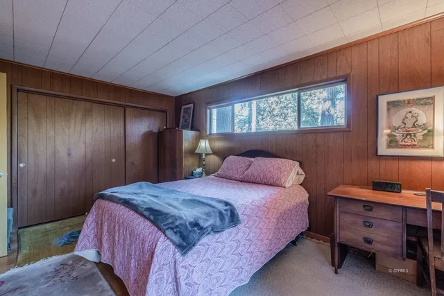 a bedroom with a bed and a desk