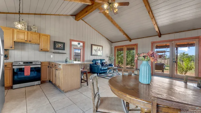 a kitchen with microwave a stove and cabinets