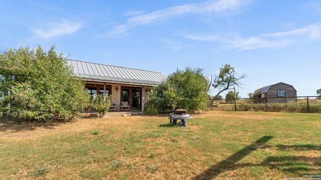 a view of a house with a yard and sitting area
