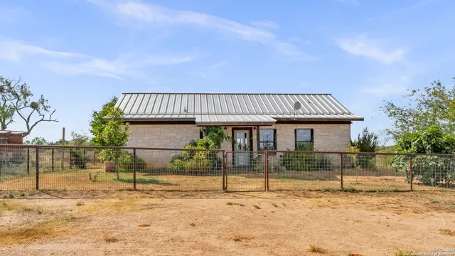 a view of a house with wooden fence