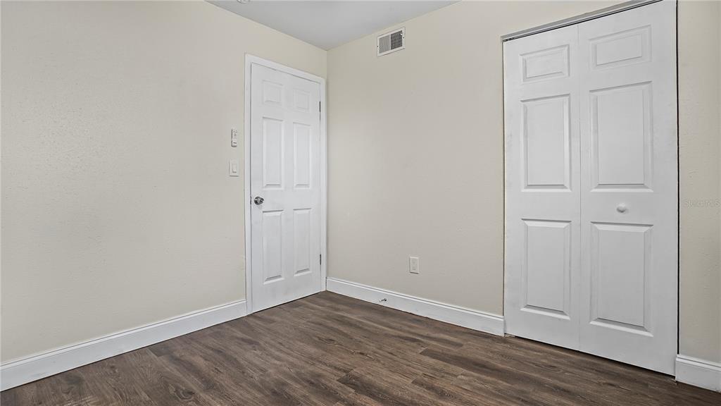 7906 Arabian Place Orlando, FL 32818 - Photo 12 of 23 a view of an empty room with wooden floor