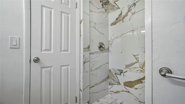 an empty room with wooden floor and window