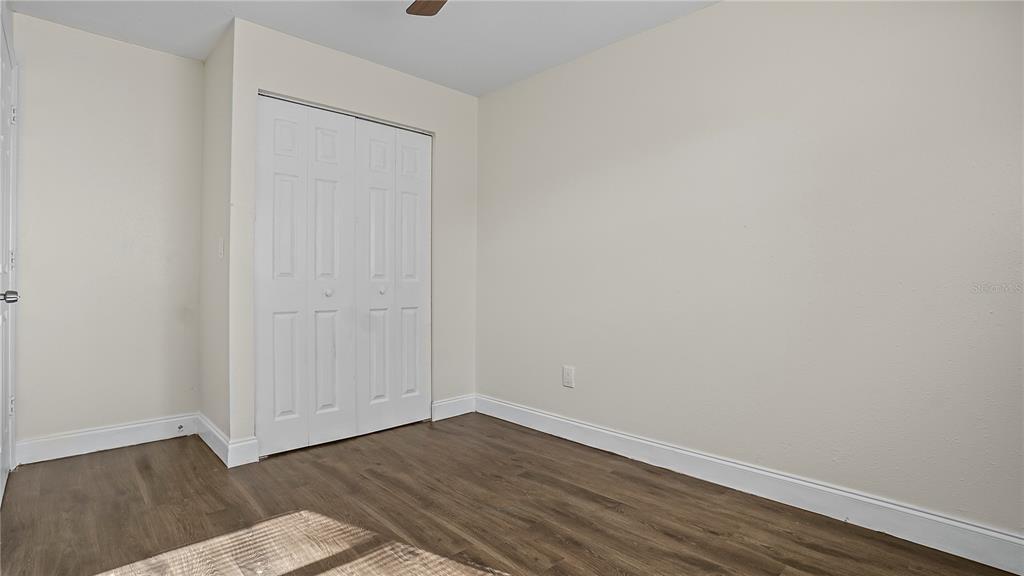 7906 Arabian Place Orlando, FL 32818 - Photo 20 of 23 a view of an empty room with wooden floor