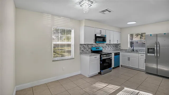 a kitchen with a sink cabinets and wooden floor