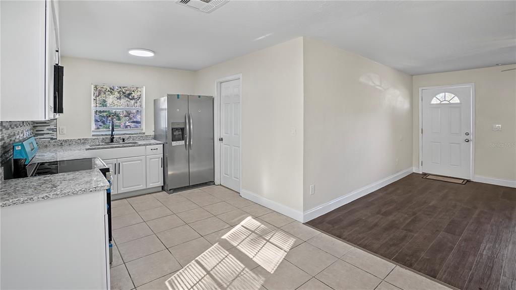 7906 Arabian Place Orlando, FL 32818 - Photo 7 of 23 a kitchen with a sink cabinets and wooden floor