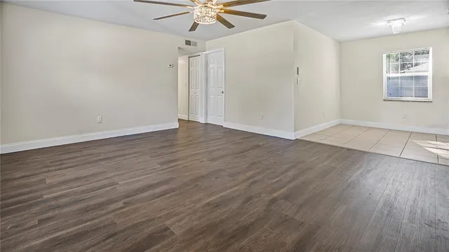 wooden floor in an empty room with a window