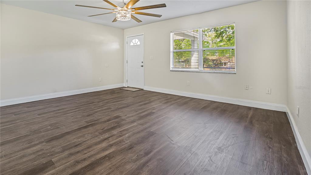 7906 Arabian Place Orlando, FL 32818 - Photo 10 of 23 wooden floor in an empty room with a window