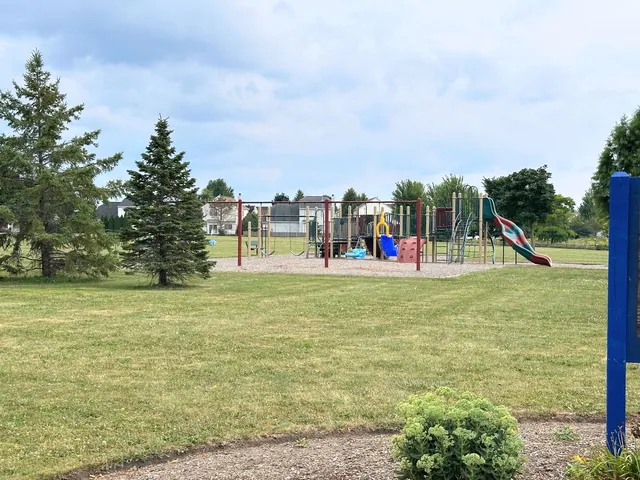 a view of a park with swings and slides