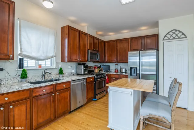 a kitchen with stainless steel appliances granite countertop a refrigerator sink and cabinets