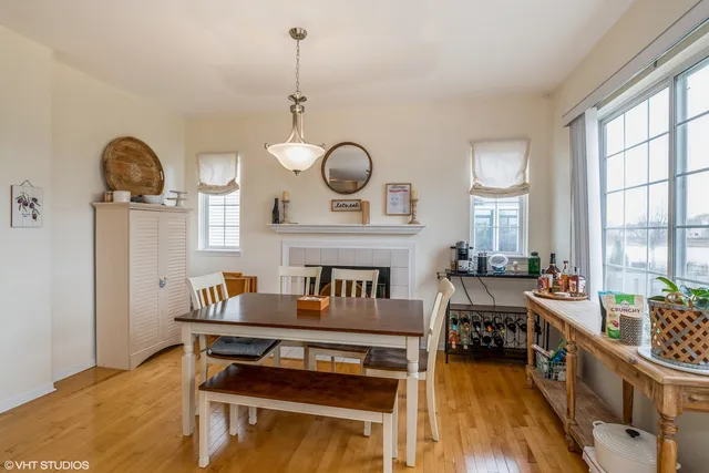 a living room with furniture a fireplace and a large window