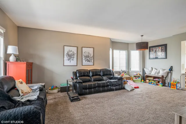 a living room with furniture chess board and a couch