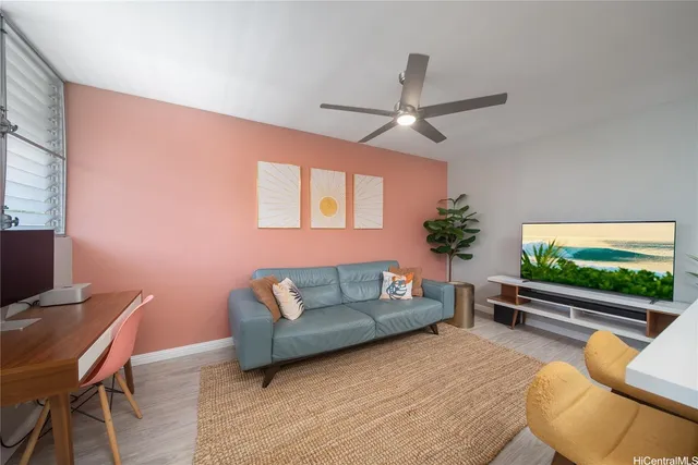 a living room with furniture a flat screen tv and a floor to ceiling window