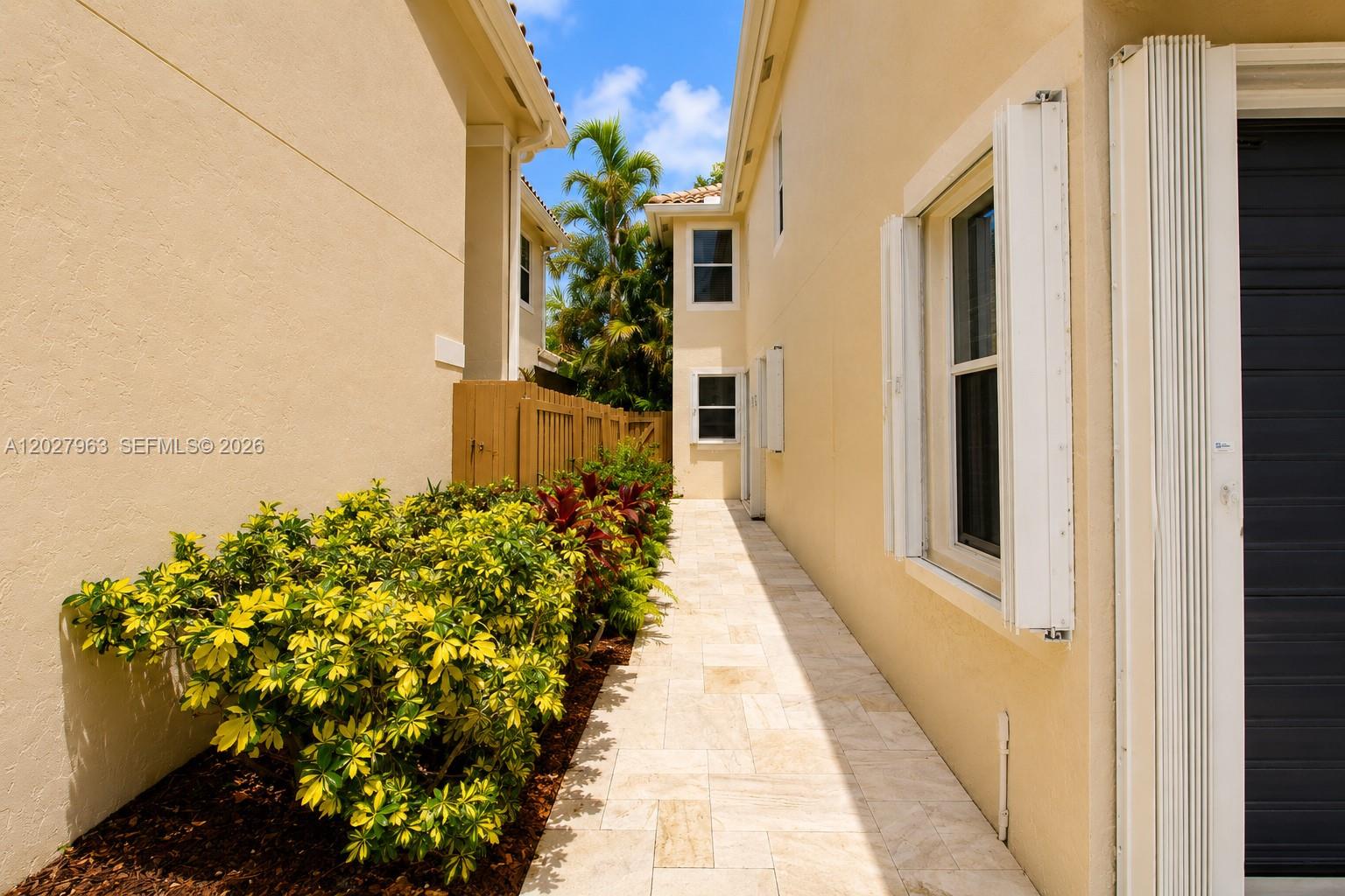 6646 Northwest 25th Terrace Boca Raton, FL 33496 - Photo 38 of 48 a view of a pathway with flower plants