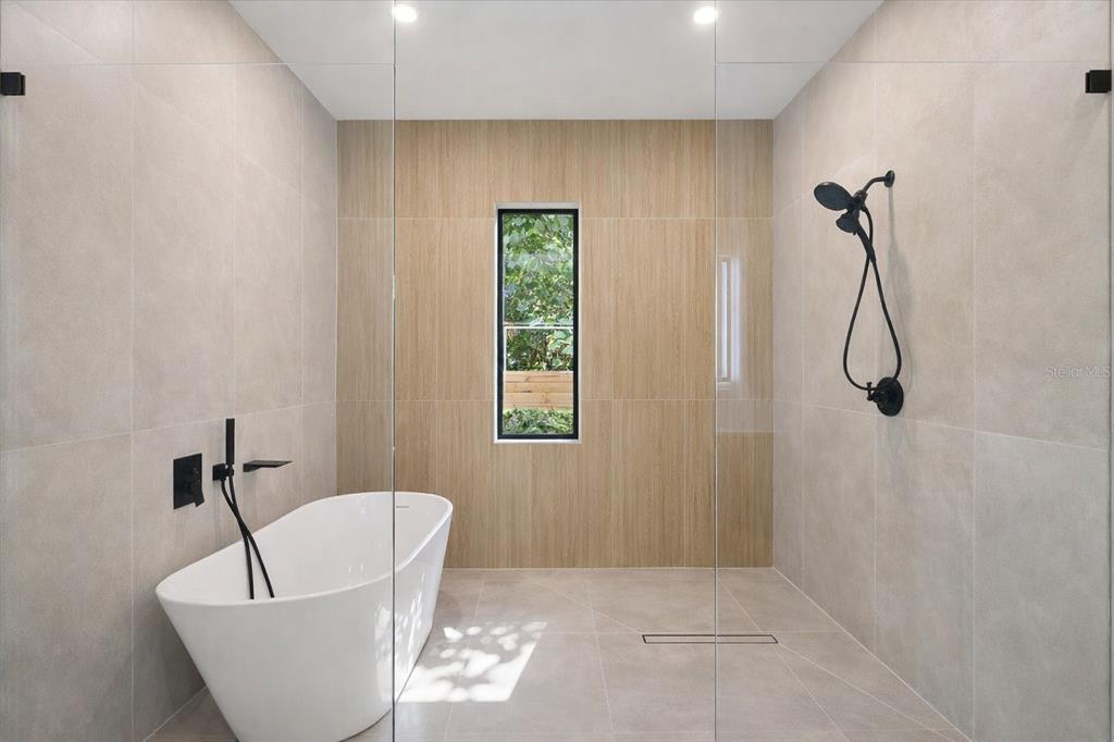 2441 Webber Street Sarasota, FL 34239 - Photo 11 of 19 a bathroom with a bathtub and a shower