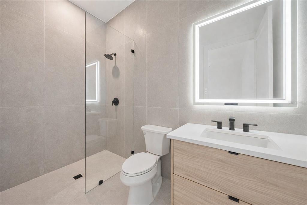 2441 Webber Street Sarasota, FL 34239 - Photo 14 of 19 a bathroom with a sink a toilet and shower
