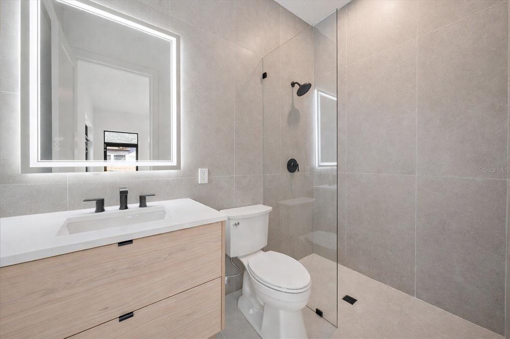 2441 Webber Street Sarasota, FL 34239 - Photo 16 of 19 a bathroom with a sink a toilet and shower