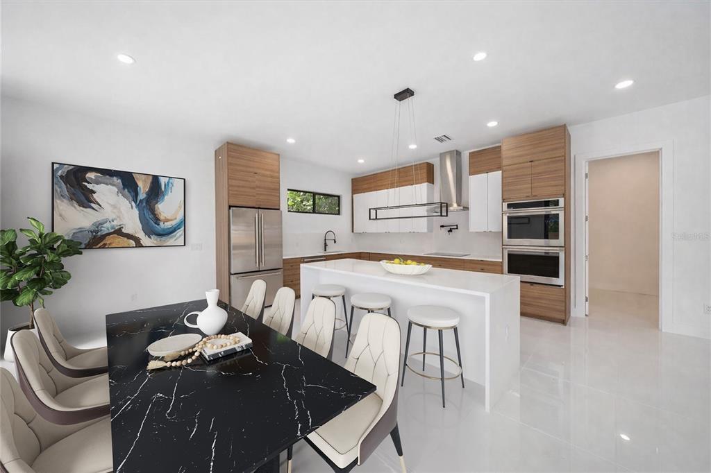 2441 Webber Street Sarasota, FL 34239 - Photo 8 of 19 a kitchen with stainless steel appliances wooden floor dining table and chairs