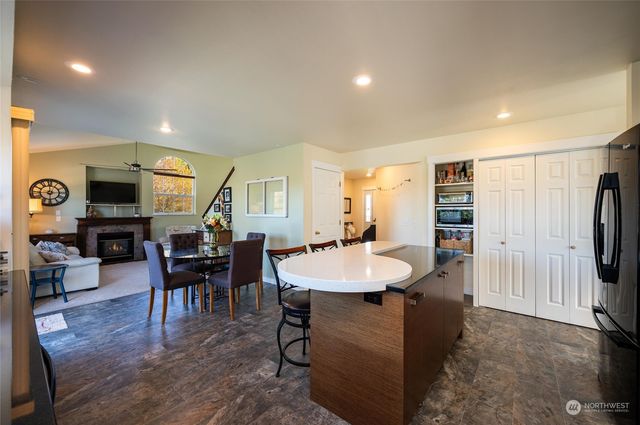 a view of a a dining room with furniture window and wooden floor