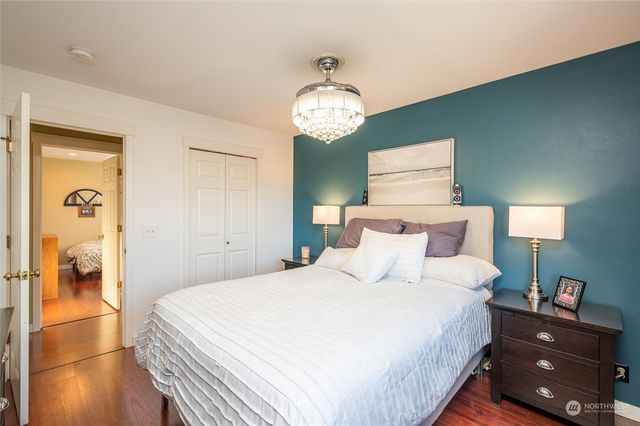 a bedroom with a bed and a chandelier