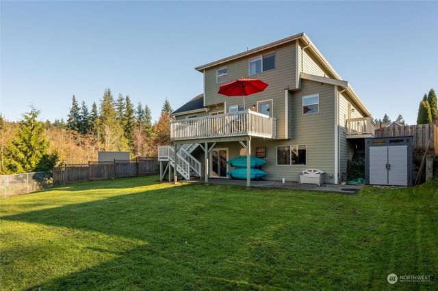 a view of a house with a yard and sitting area