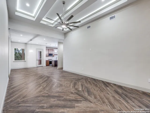 wooden floor in an empty room with a window
