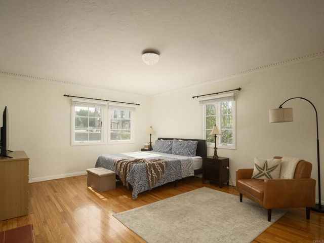 a bedroom with a bed couch and a window