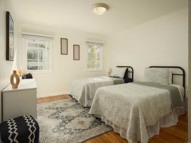 a bedroom with two beds and a dresser