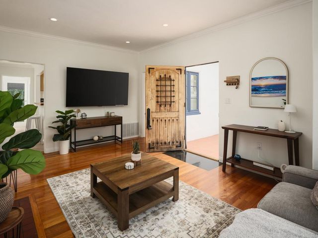 a living room with furniture and a flat screen tv