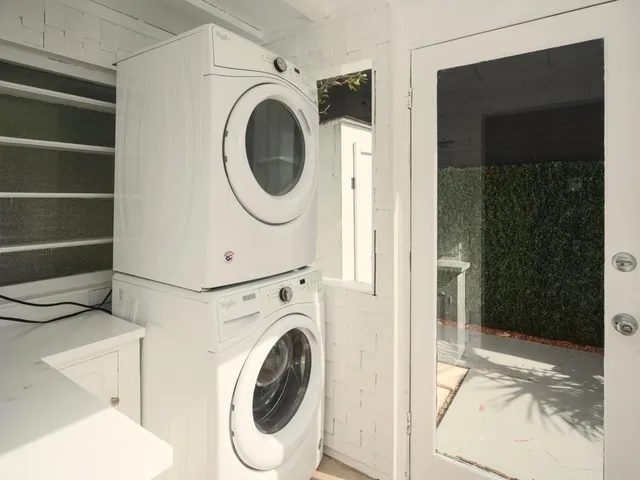 a view of a hallway with washer and dryer