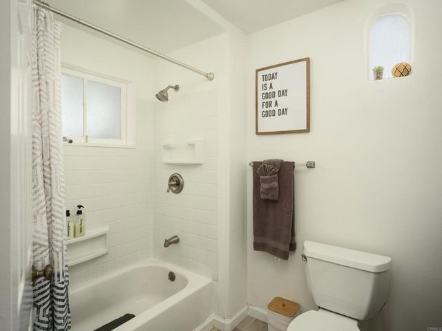 a bathroom with a toilet and a bathtub
