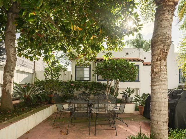 a view of a patio with table and chairs and potted plants