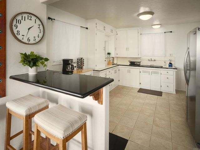 a kitchen with stainless steel appliances granite countertop a sink a stove and a refrigerator